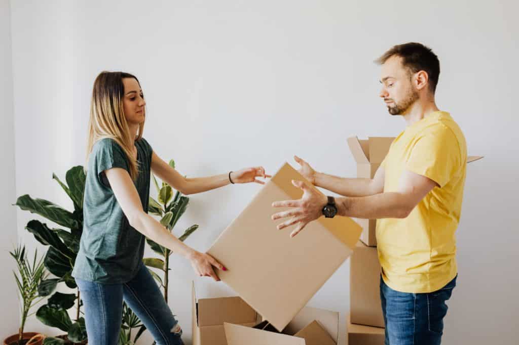 Couple Holding a Box — Removalist in Campbelltown NSW 2560